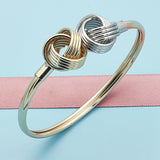 Oro Laminado Individual Bangle, Gold Filled Style Love Knot Design, Diamond Cutting Finish, Two Tone